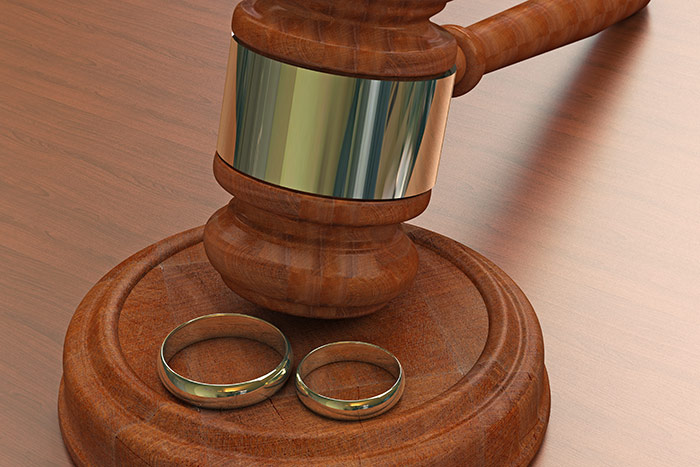 legal gavel with wedding bands